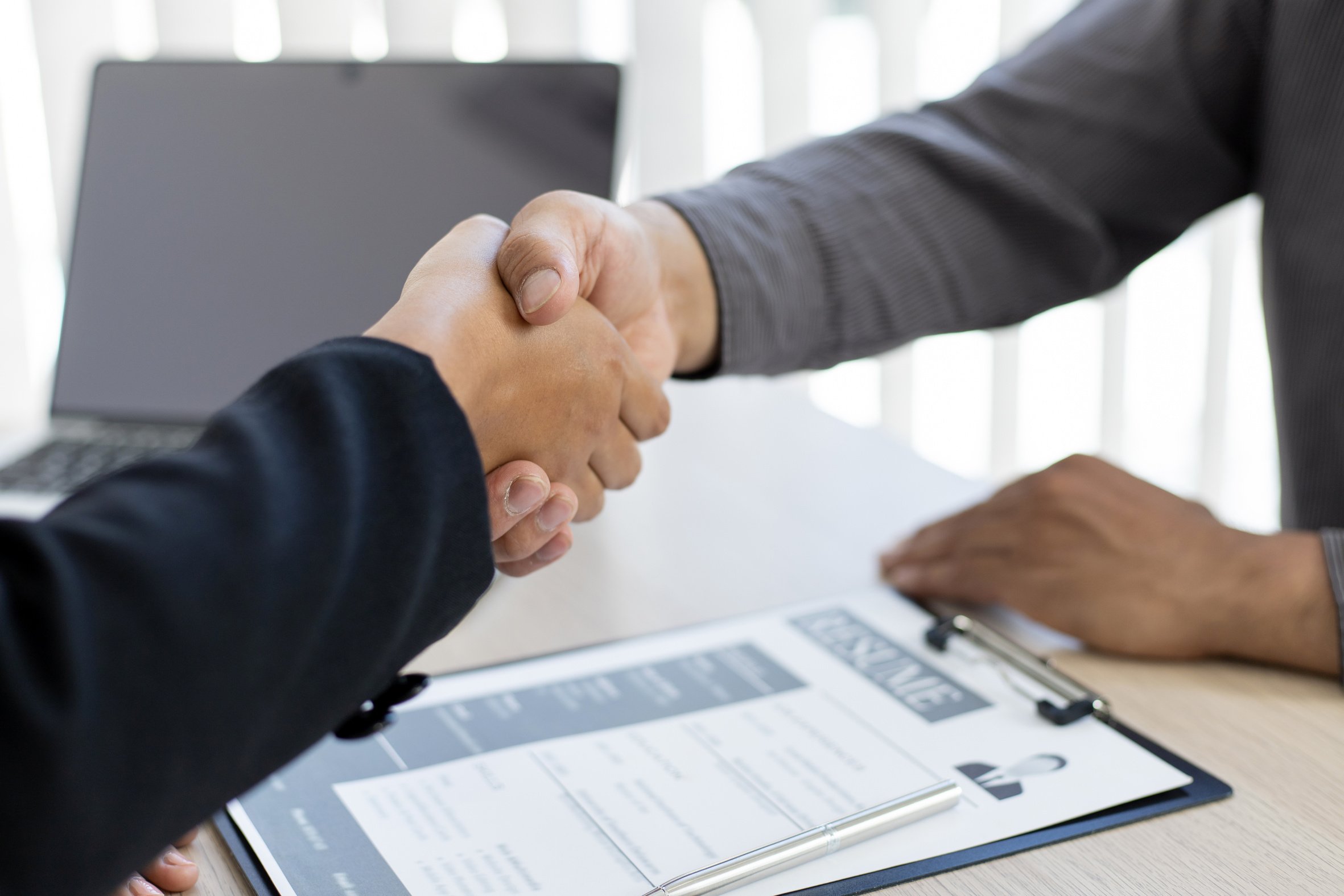 Handshake between Human Resources Manager and Applicant 